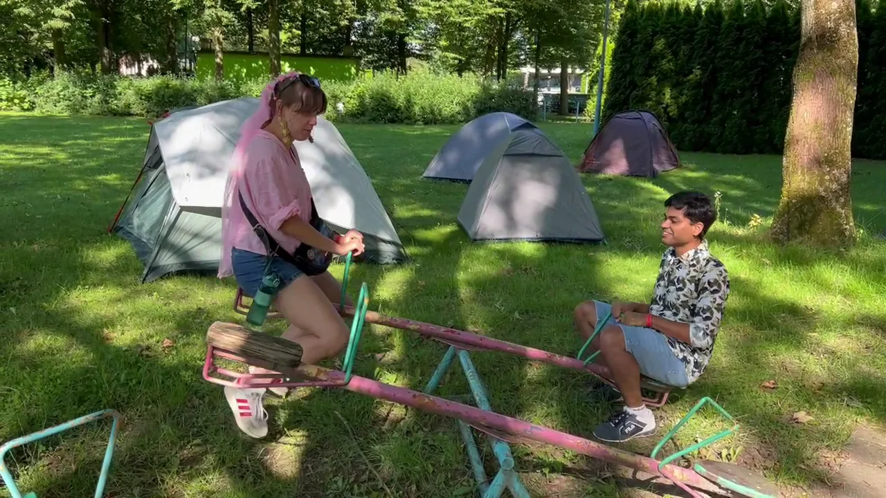 Friends at a grassy Malbork campsite in summer