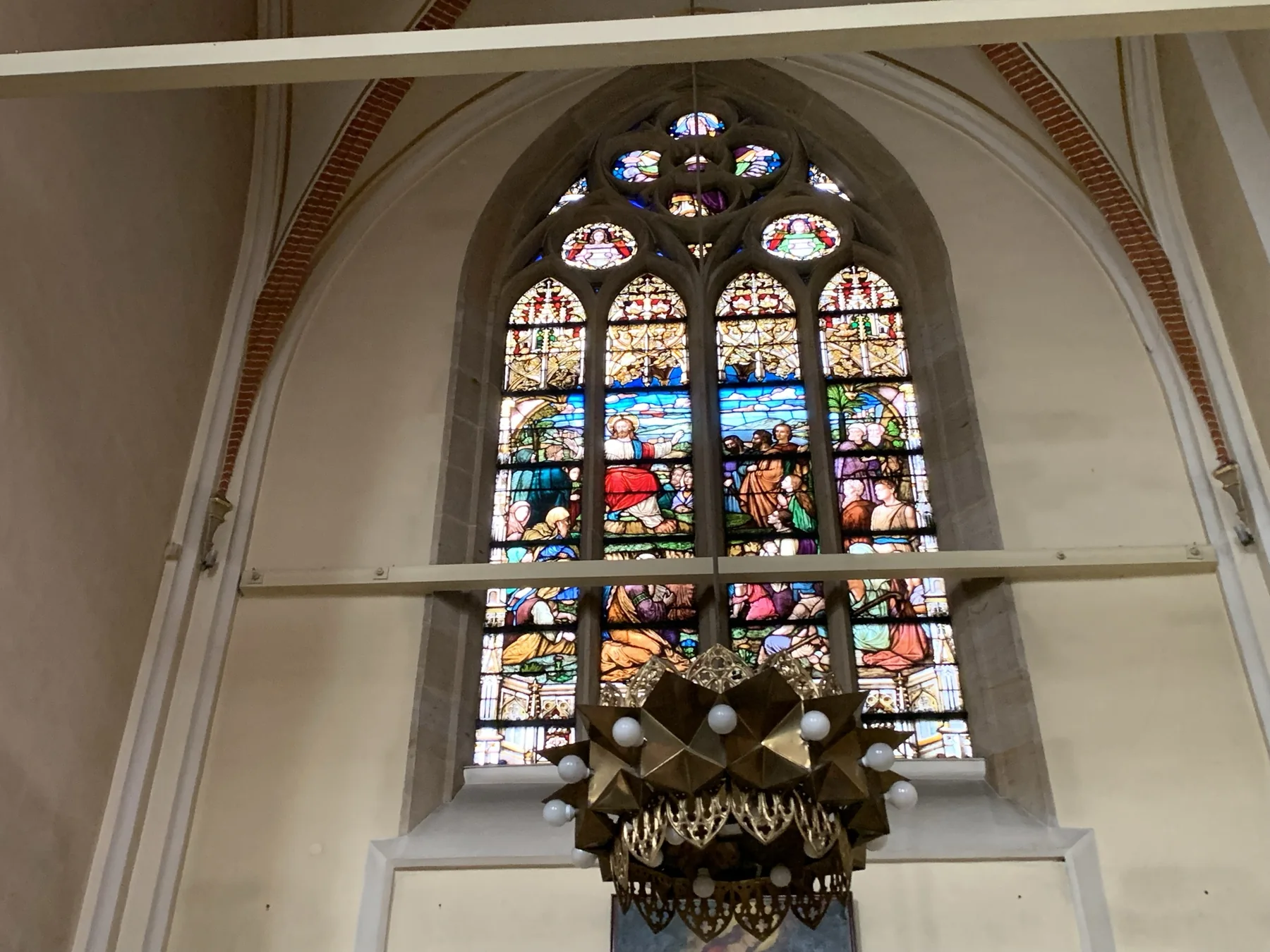 Stained glass set within the architecture of a church interior in Katowice.