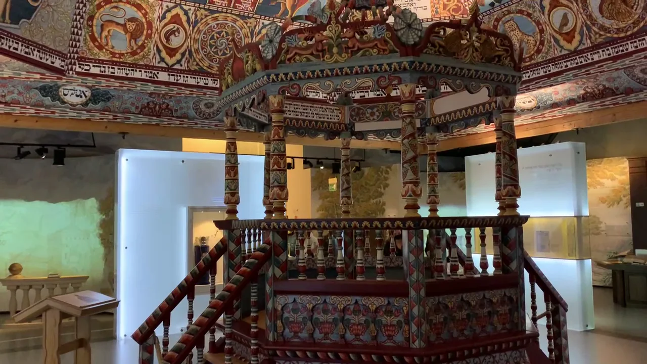 The reconstructed bimah and painted ceiling of the Gwoździec wooden synagogue at POLIN Museum.