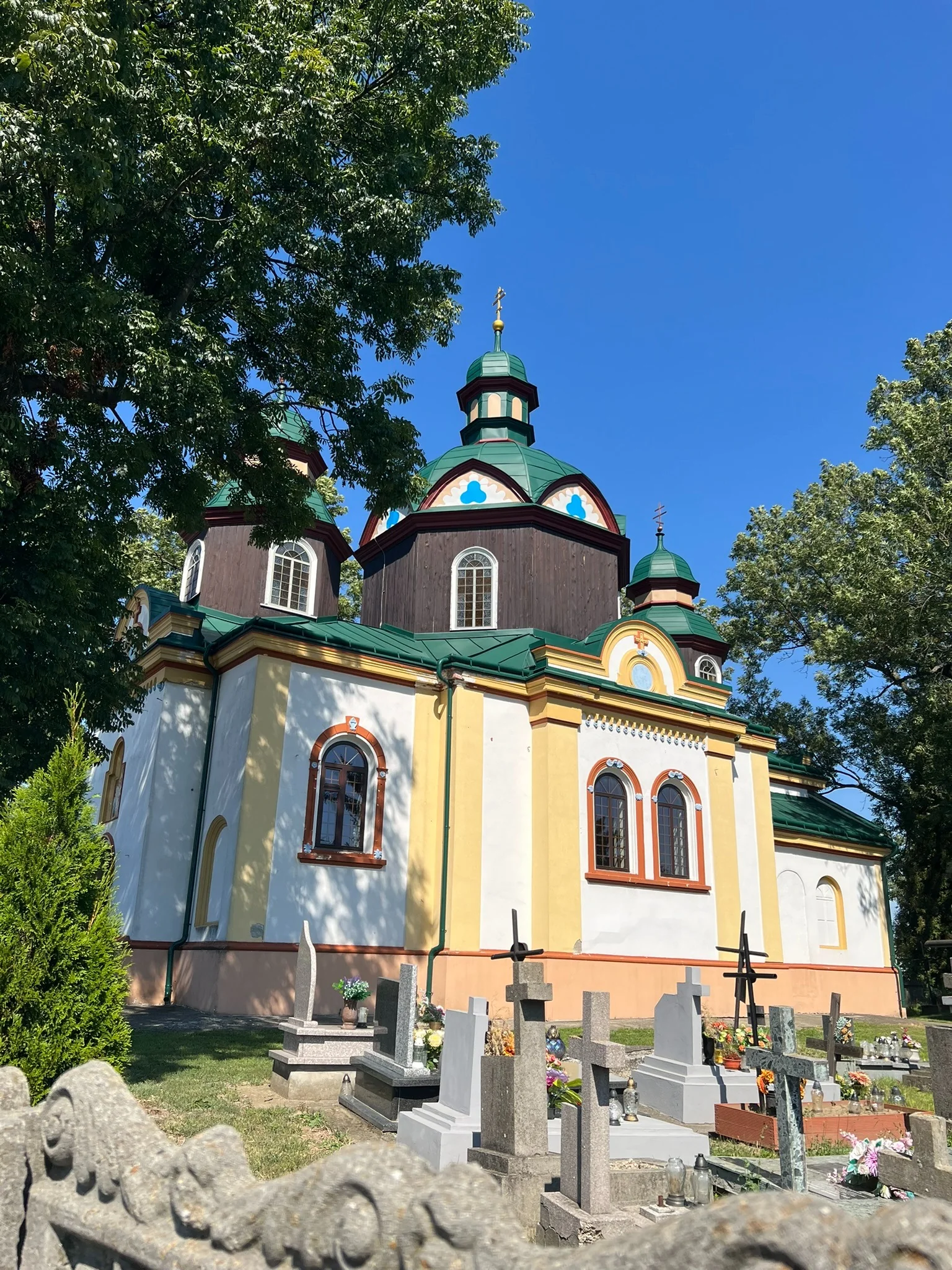 An Eastern Christian church in Przemyśl seen across its cemetery.