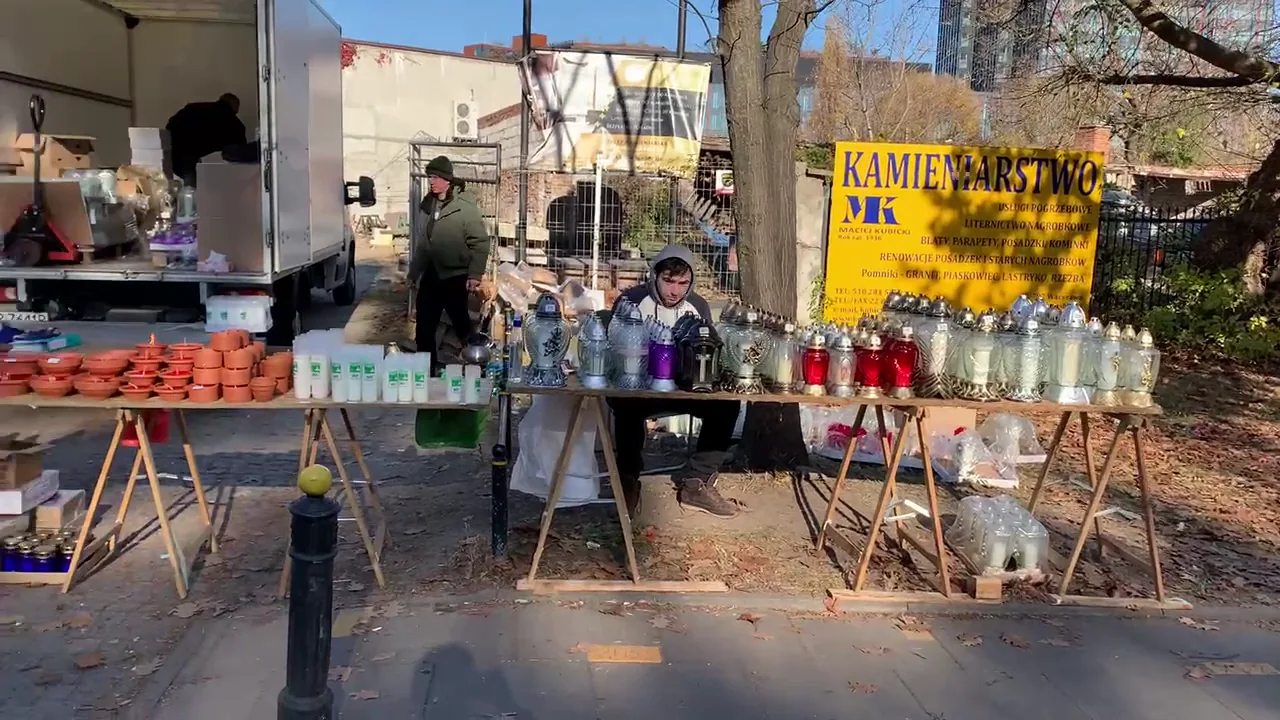 Roadside stall displaying many kinds of Polish grave lanterns and candles