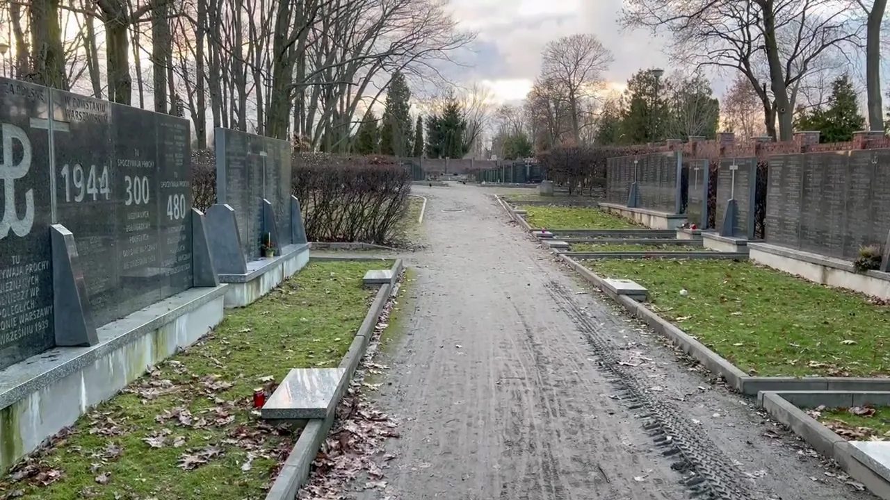 Original photograph of The cemetery’s aligned mass graves make its scale visible without reducing each  at Warsaw Insurgents Cemetery