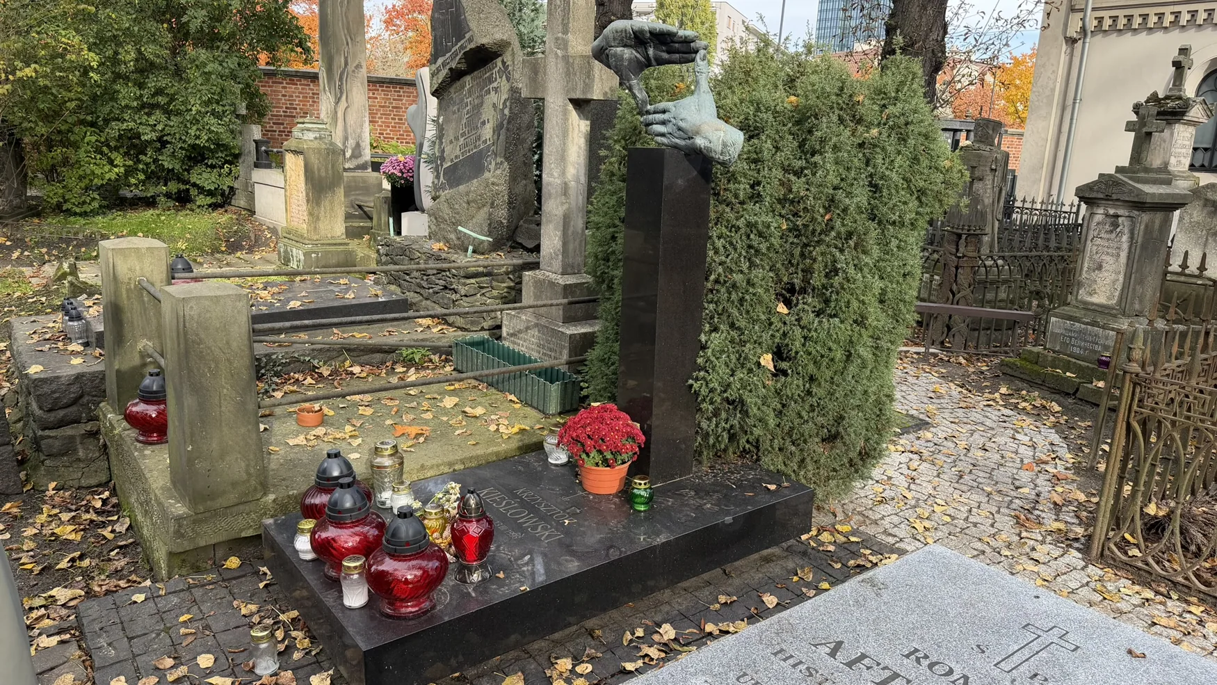 Quiet autumn avenue with historic gravestones at Old Powązki