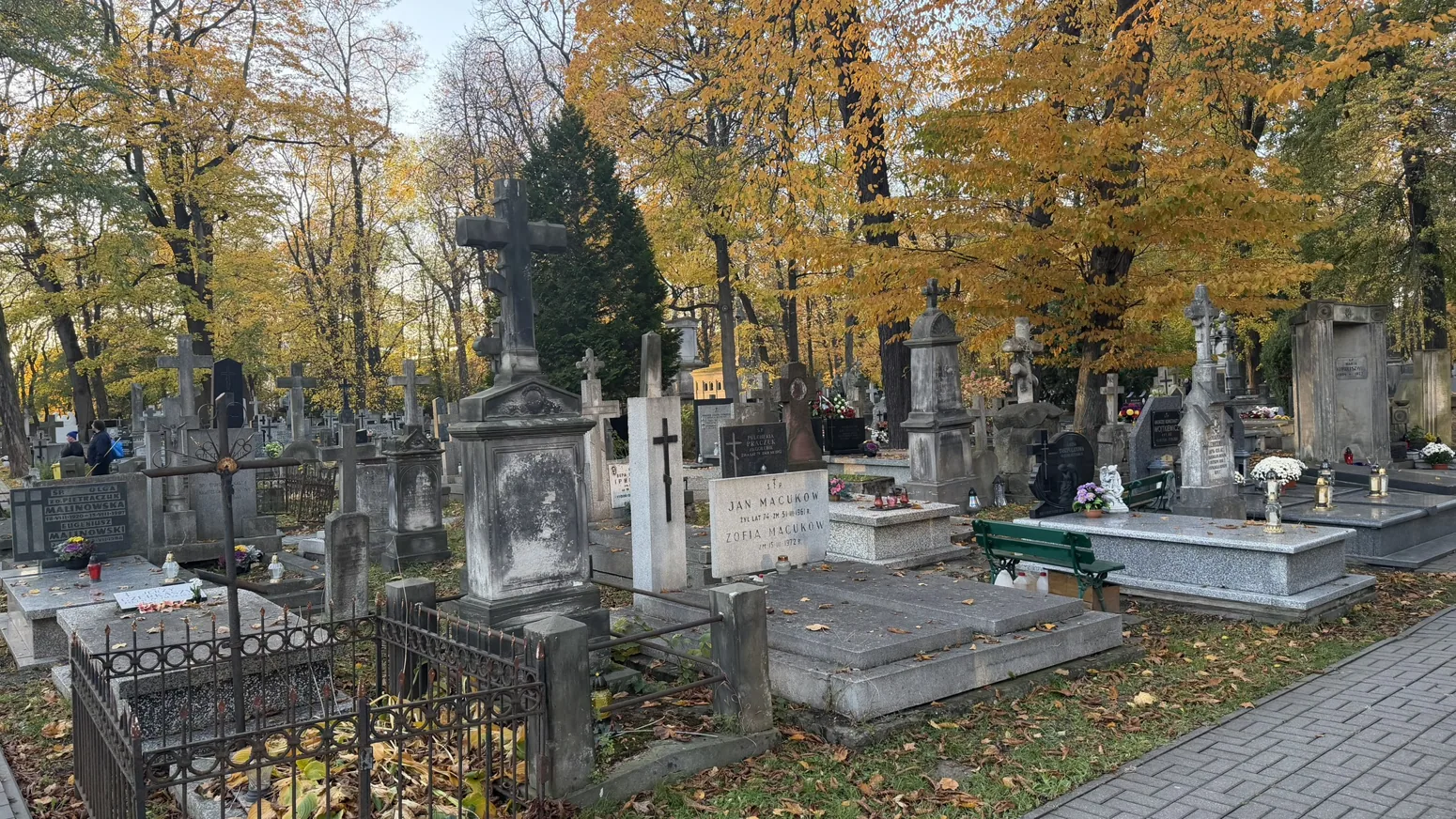Photograph of Warsaw Orthodox Cemetery: Rows of graves and Orthodox crosses in the autumn light.