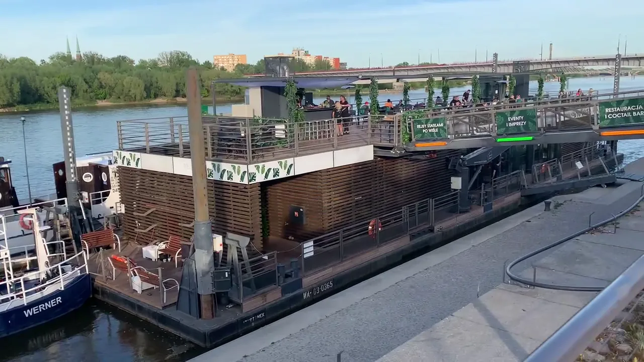 Floating riverside restaurant with terrace and seating on the Vistula