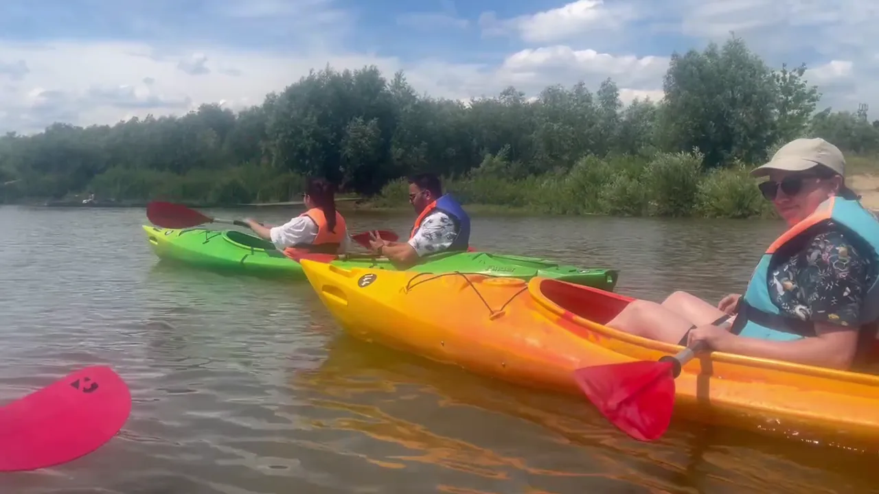 Group kayaking in colourful boats on a calm stretch of the Vistula