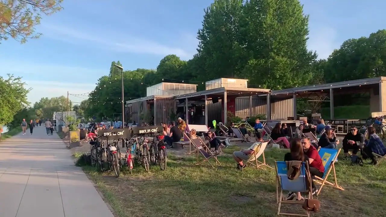 People relaxing in deckchairs at a casual Warsaw riverside bar